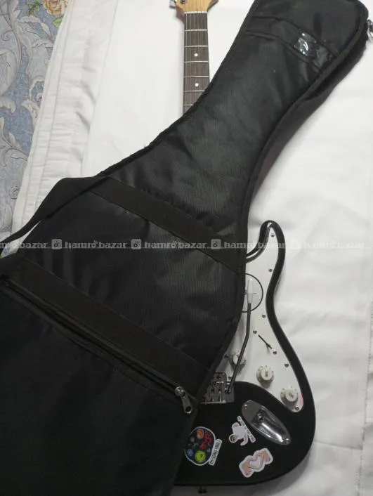 Electric guitar with its bag, amp and strap